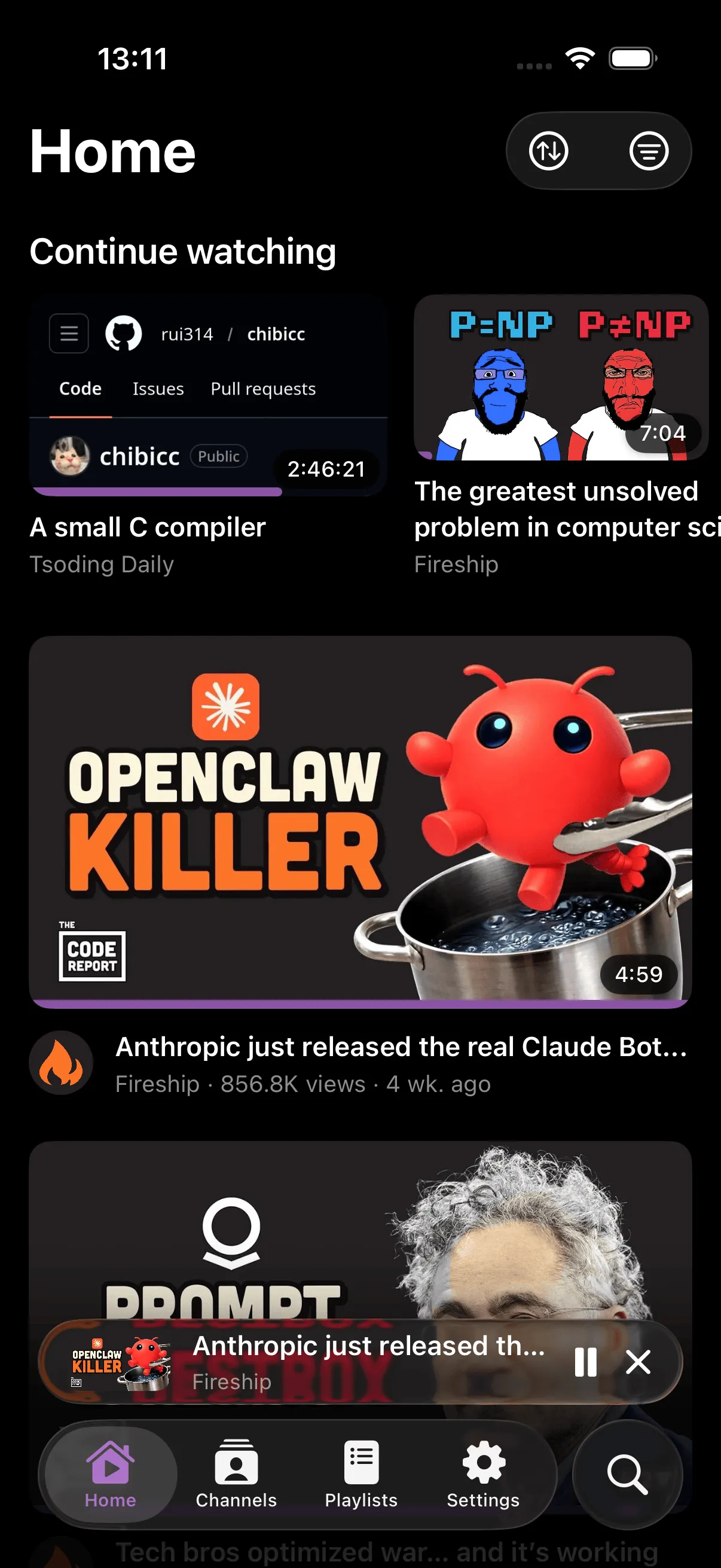 SwiftTube home screen showing video feed with the mini player docked at the bottom